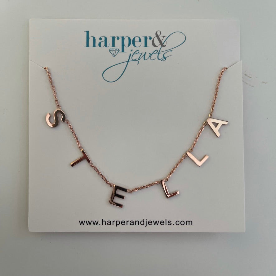 This is an image of our hanging name necklace in rose gold/ stella on a white background