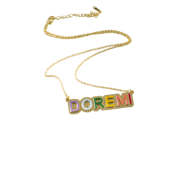 This is an image of our gold rainbow iced out nameplate necklace on a white background