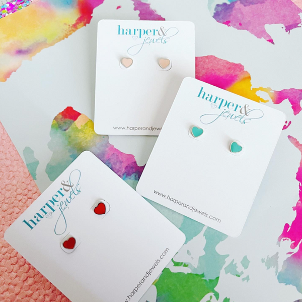 This is an image of our pink, red, and mint mini heart earrings on a water color background