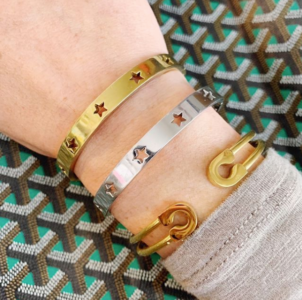 this is an image with our gold safety pin cuff bracelet being worn 