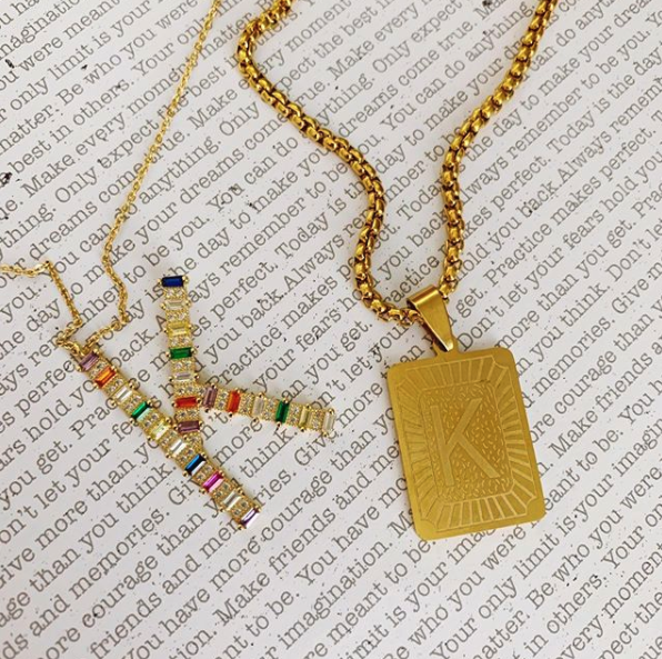 This is an image of our rainbow cz K necklace and our gold K rectangle medallion necklace
