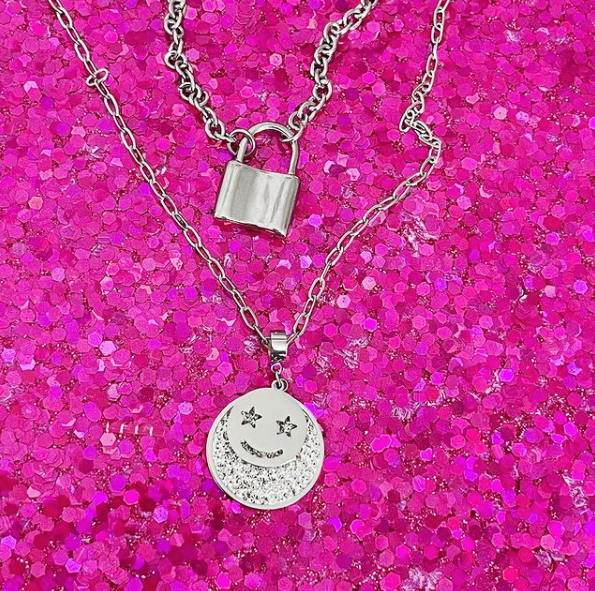 lock necklace layered with smiley face necklace