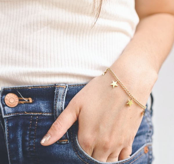 This is an image of our star charm bracelet on a model with jeans.