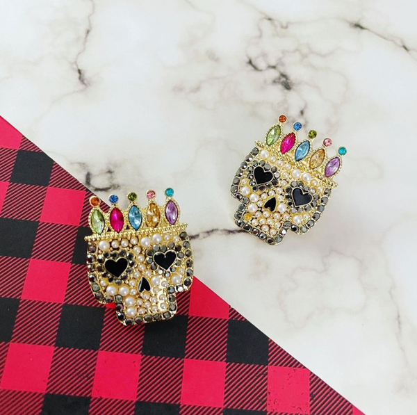 sugar skull statement earrings on a marble and plaid background