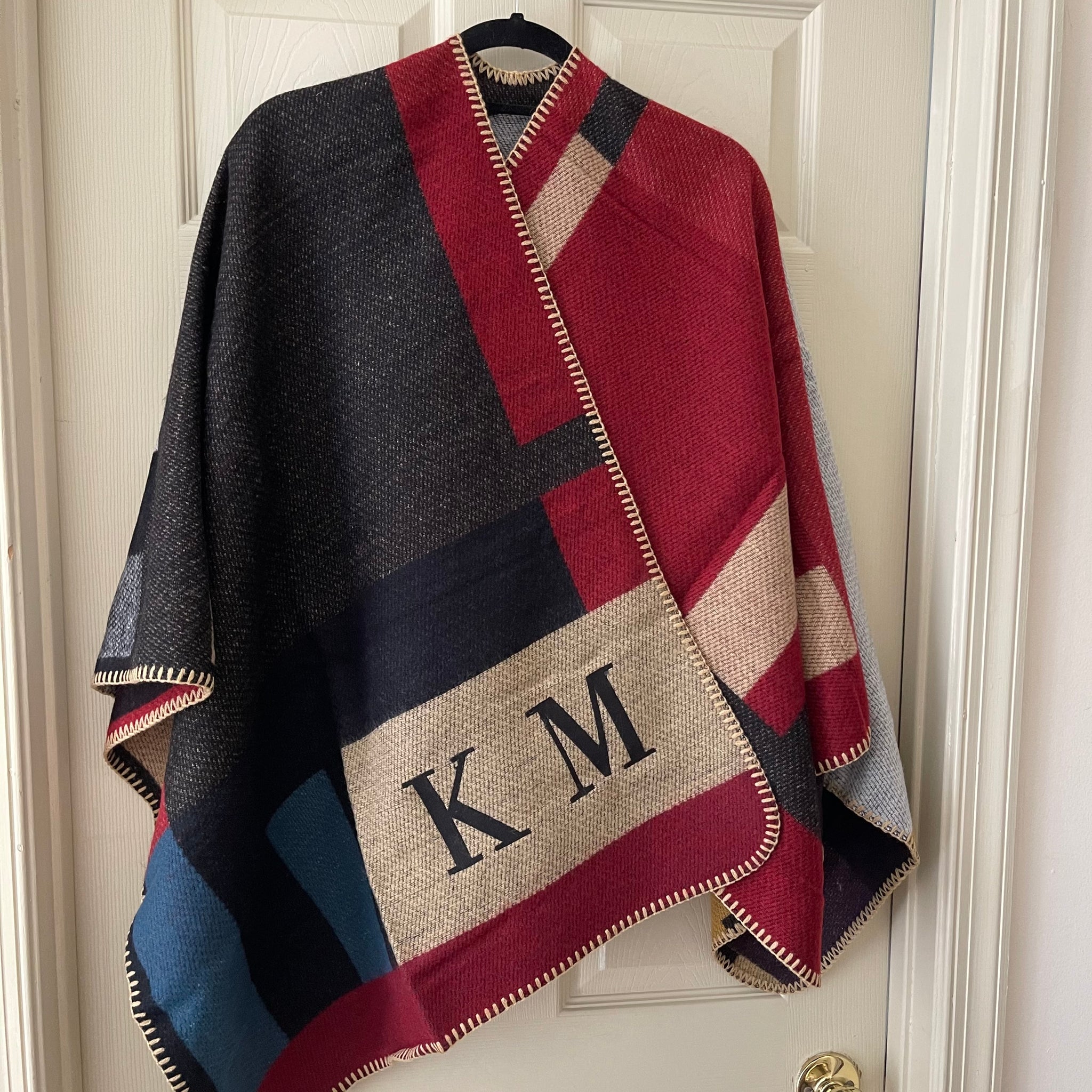 this is an image of our multi colored plaid poncho with initials KM